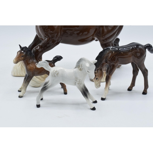 150 - A collection of Beswick horses to include brown cantering shire, brown outstretched foal, grey foal ... 