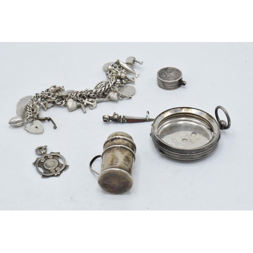 208 - A collection of mostly hallmarked silver items to include a charm bracelet, pocket watch case, a fob... 