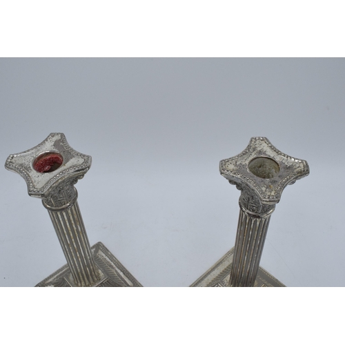 215 - A pair of vintage 20th century silver plated Corinthian column candlesticks, 21cm tall.