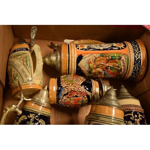 24 - A  collection of vintage 20th century German stein ceramic and metal tankards of varying forms and s... 