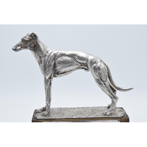 251 - A silver plated model of a realistically modelled greyhound on wooden base with matching plaque '196... 