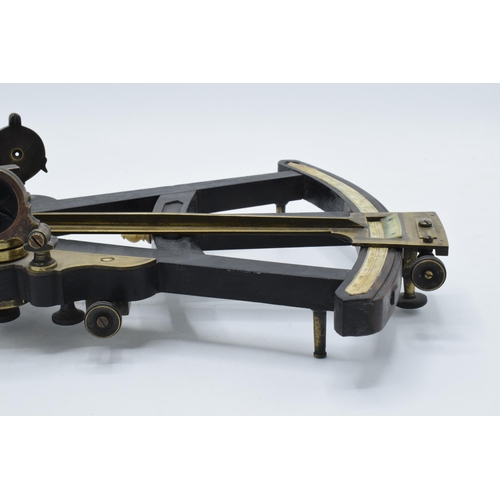 263 - A late 19th century nautical brass and ebonised wooden vernier sextant, unmarked, 31 x 25cm.