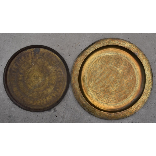 279A - A pair of 19th century brass chargers of Islamic / Middle Eastern design, largest 70cm diameter with... 