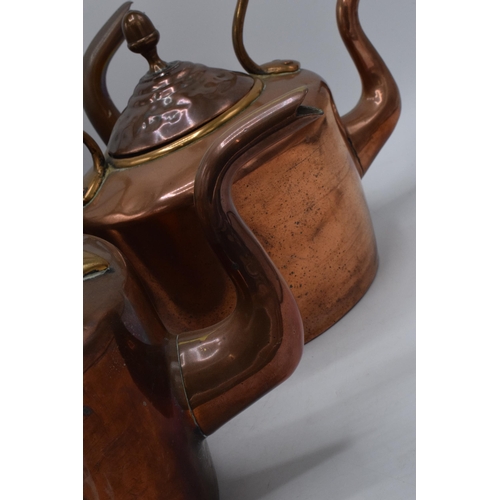 280 - A trio of Victorian brass and copper kettles with one having a hinged lid, tallest 32cm tall (3).