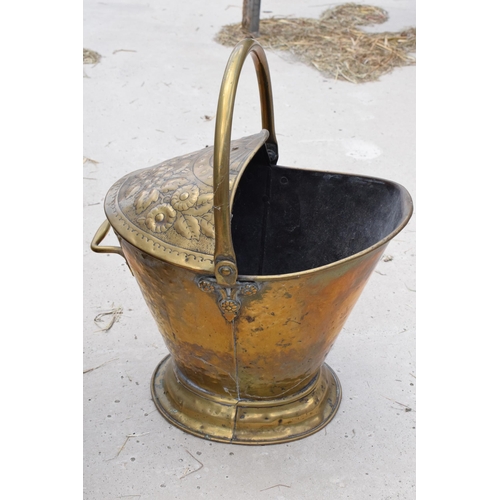 282 - A late 19th century embossed copper coal bucket together with a 20th century wooden and brass exampl... 