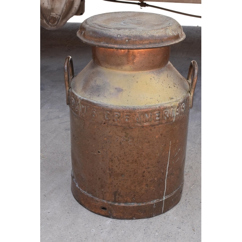 284 - An early 20th century copper milk churn 'Daw's Creameries' complete with lid, 52cm tall.