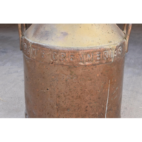 284 - An early 20th century copper milk churn 'Daw's Creameries' complete with lid, 52cm tall.