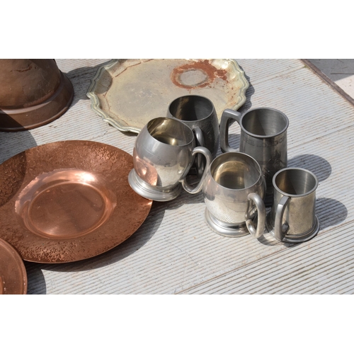 285 - A collection of metalware to include Victorian copper jug and later brass pans, plaques, tankards et... 