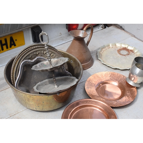 285 - A collection of metalware to include Victorian copper jug and later brass pans, plaques, tankards et... 