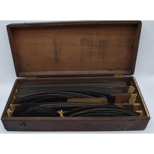 287 - A cased set of early 20th century draughtsman templates of varying sizes in a rectangular mahogany c... 