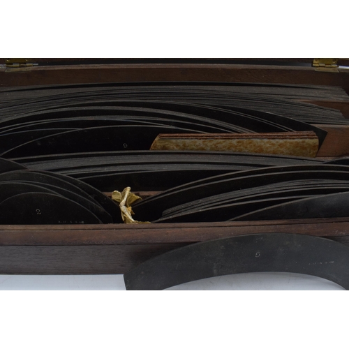 287 - A cased set of early 20th century draughtsman templates of varying sizes in a rectangular mahogany c... 