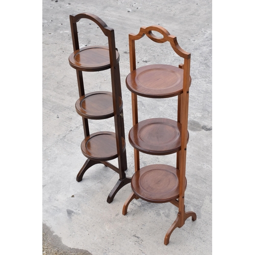 294 - A pair of mid 20th century wooden lazy waiter/ folding 3 tiered stands (2). 92cm tall.