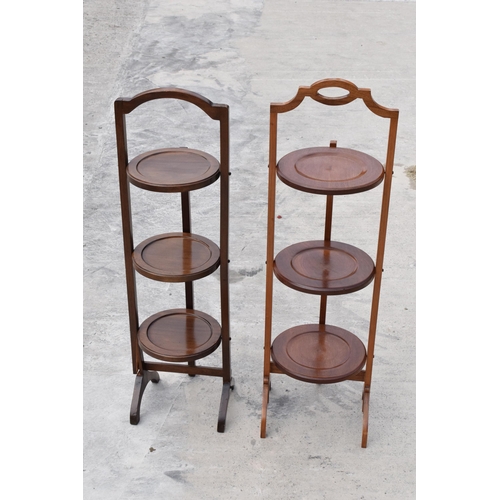 294 - A pair of mid 20th century wooden lazy waiter/ folding 3 tiered stands (2). 92cm tall.