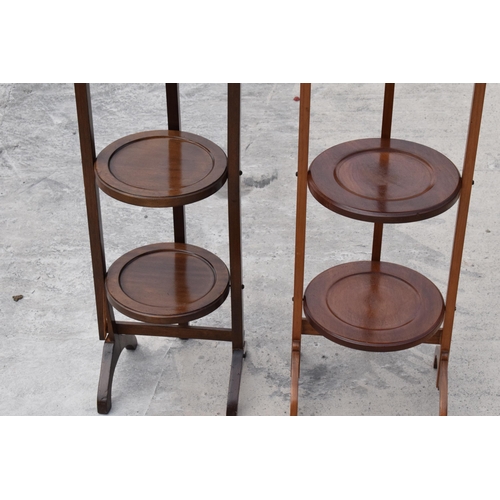 294 - A pair of mid 20th century wooden lazy waiter/ folding 3 tiered stands (2). 92cm tall.