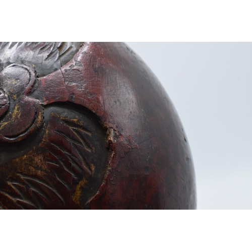 308 - Carved antique wooden Tibetan cow bell, 20.5cm tall.