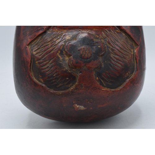308 - Carved antique wooden Tibetan cow bell, 20.5cm tall.