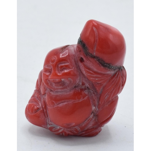 309 - Red hard stone Netsuke type toggle with small pierced hole through top section, 4cm tall.