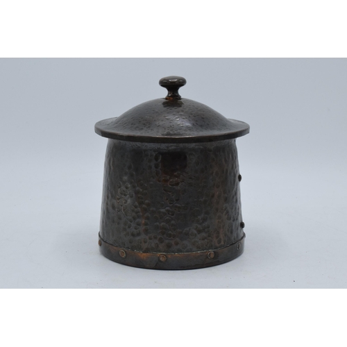 312 - Arts and Crafts hammered copper lidded jar with riveted decoration, 13.5cm tall.