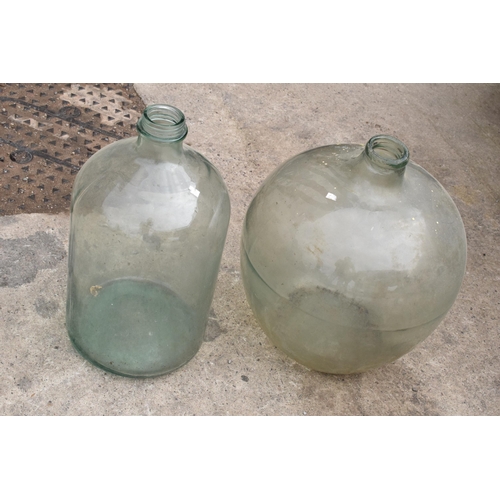 322 - A large globular glass jar together with one similar example, tallest 57cm.