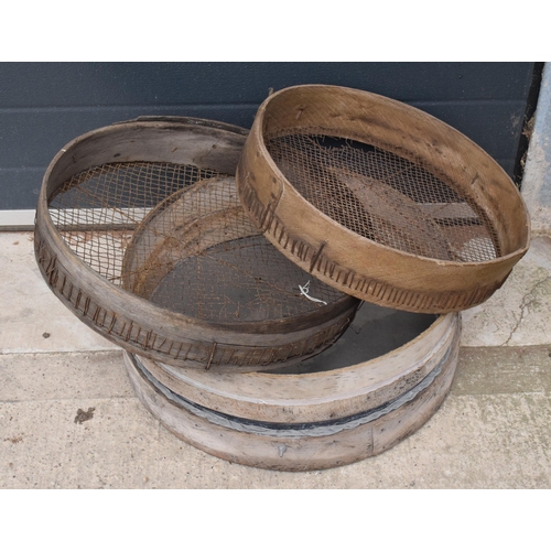 327 - A trio of vintage wooden gardening sieves, largest 53cm diameter.