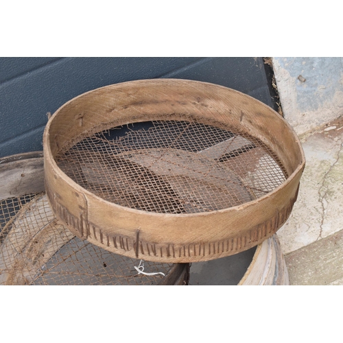 327 - A trio of vintage wooden gardening sieves, largest 53cm diameter.