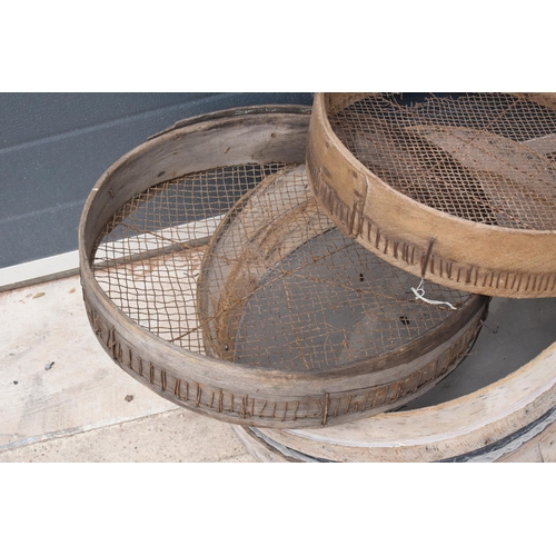 327 - A trio of vintage wooden gardening sieves, largest 53cm diameter.