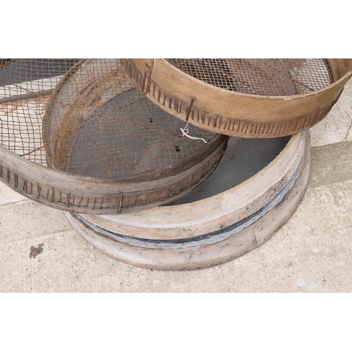 327 - A trio of vintage wooden gardening sieves, largest 53cm diameter.