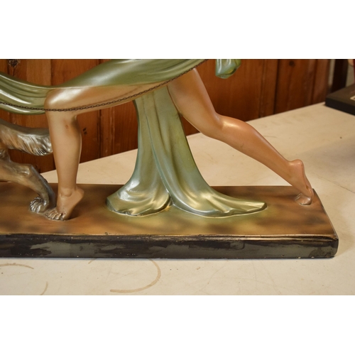 357 - Art Deco 1930s plaster figure of a girl walking a dog, Reg Number 8330, 74cm long.