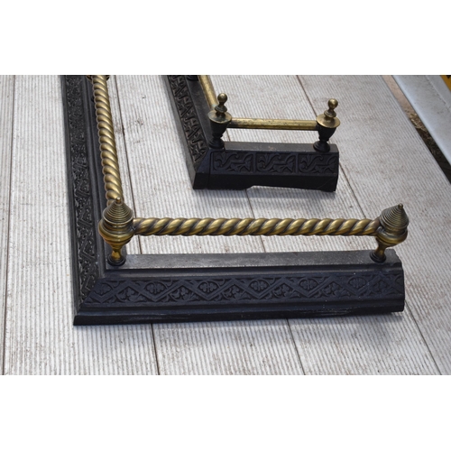 373 - A near pair of late 19th century metal and brass fire fenders, largest exteriors 145 x 50cm (2).