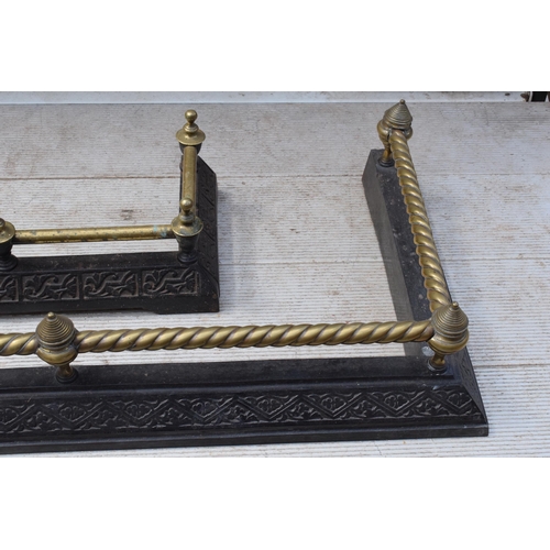 373 - A near pair of late 19th century metal and brass fire fenders, largest exteriors 145 x 50cm (2).