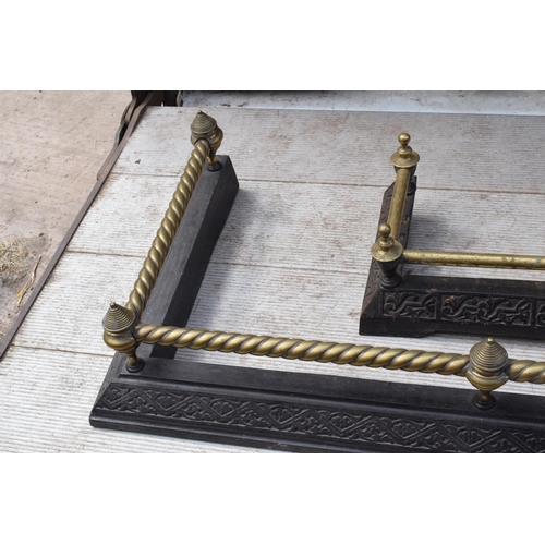 373 - A near pair of late 19th century metal and brass fire fenders, largest exteriors 145 x 50cm (2).