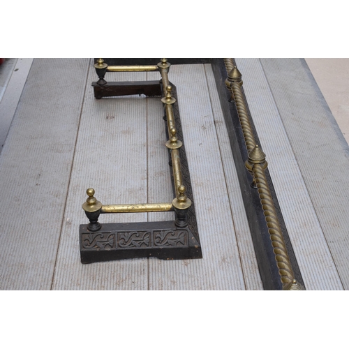 373 - A near pair of late 19th century metal and brass fire fenders, largest exteriors 145 x 50cm (2).