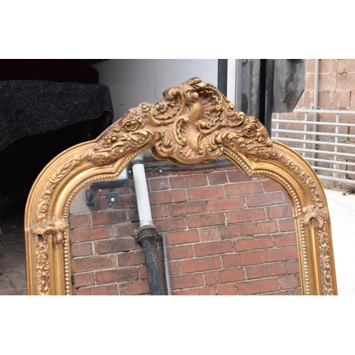 379 - A large vintage gilt-style hanging over mantle mirror, 118cm tall.