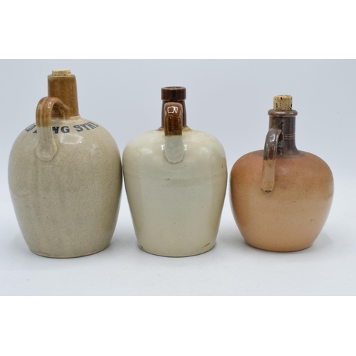 61A - A trio of stoneware whisky flagons to include Auld Lang Syne H Kennedy Glasgow, The Kintore Scotch W... 