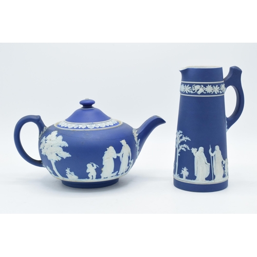 78 - Wedgwood dark blue Jasperware teapot together with a tall jug with unusual handle (2).