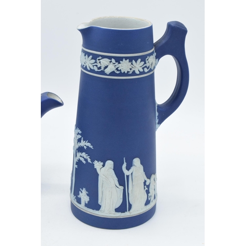 78 - Wedgwood dark blue Jasperware teapot together with a tall jug with unusual handle (2).