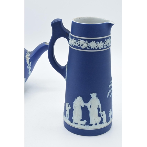 78 - Wedgwood dark blue Jasperware teapot together with a tall jug with unusual handle (2).