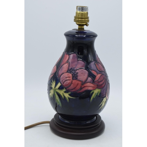 166 - Moorcroft pottery lamp base with floral design on blue pattern, 28cm inc fittings.