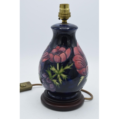 166 - Moorcroft pottery lamp base with floral design on blue pattern, 28cm inc fittings.