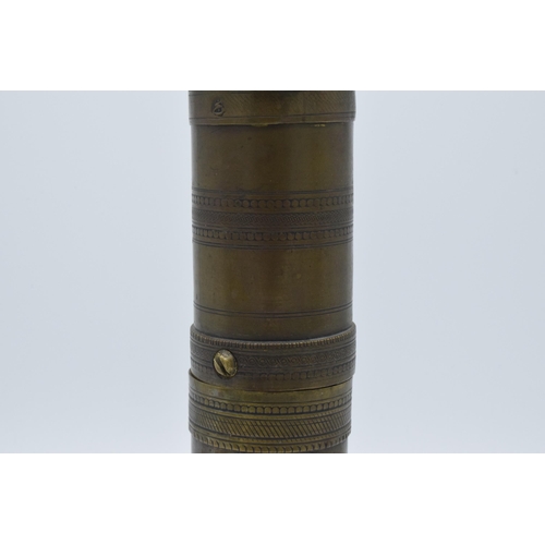 196 - 19th century brass Arabic cylindrical spice grinder, 29cm long.