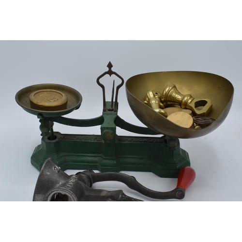 230 - A set of painted green postage scales together with small brass weights and a food grinder (Qty).