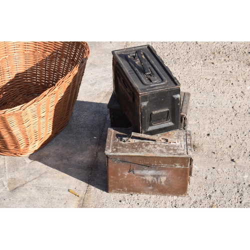 232 - A trio of vintage metal ammunition boxes together with a vintage wicker basket, 63cm at widest (4).