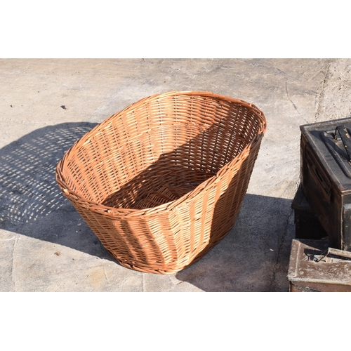 232 - A trio of vintage metal ammunition boxes together with a vintage wicker basket, 63cm at widest (4).