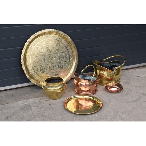 234 - A collection of quality brass and copper items to include brass coal scuttles, large Eastern charger... 