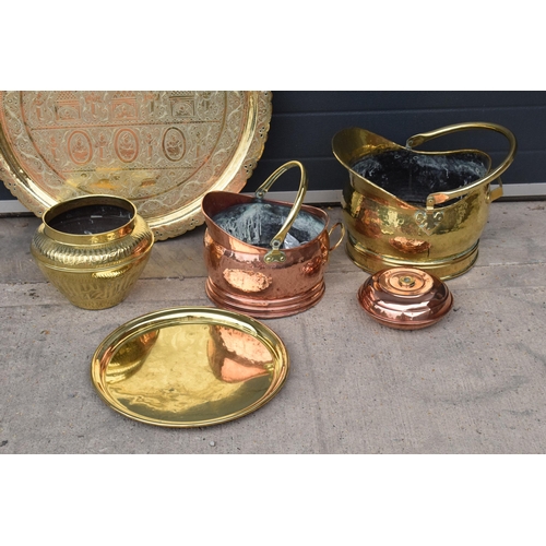 234 - A collection of quality brass and copper items to include brass coal scuttles, large Eastern charger... 