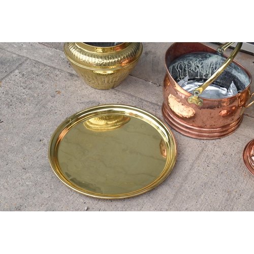 234 - A collection of quality brass and copper items to include brass coal scuttles, large Eastern charger... 