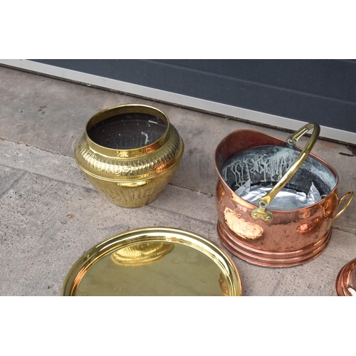 234 - A collection of quality brass and copper items to include brass coal scuttles, large Eastern charger... 