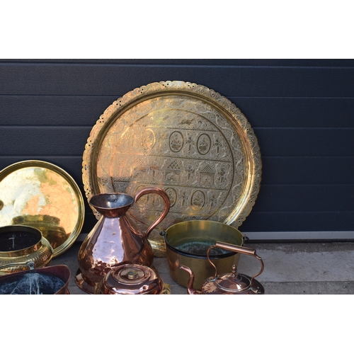 234 - A collection of quality brass and copper items to include brass coal scuttles, large Eastern charger... 