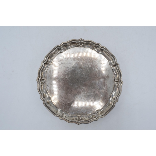 300 - Silver salver, circular form with shaped edges standing proud on 4 feet. 235.5 grams / 7.57 oz. Ches... 