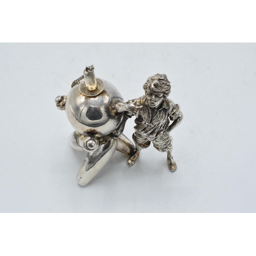 305 - Novelty silver plated table lighter in the form of a boy with bowling equipment, 9.5cm tall.